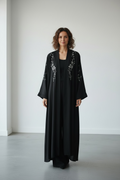 Black abaya with floral crystal stone embellishments on the front panels front view