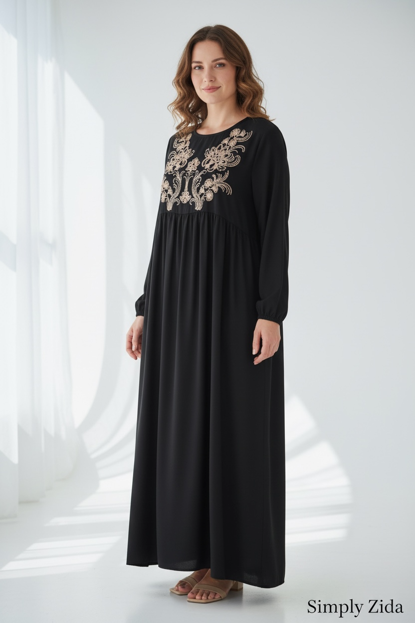 Black embroidered maxi abaya with gold floral detailing and relaxed modest fit shown from side.