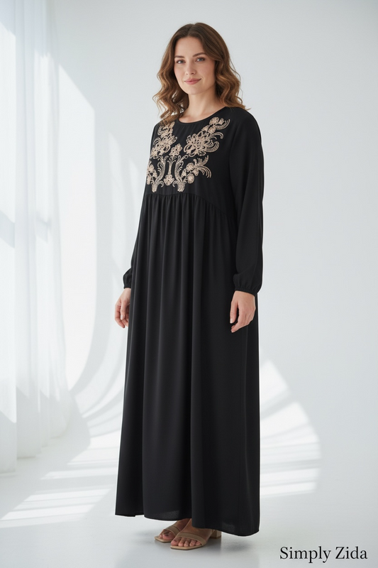 Black embroidered maxi abaya with gold floral detailing and relaxed modest fit shown from side.