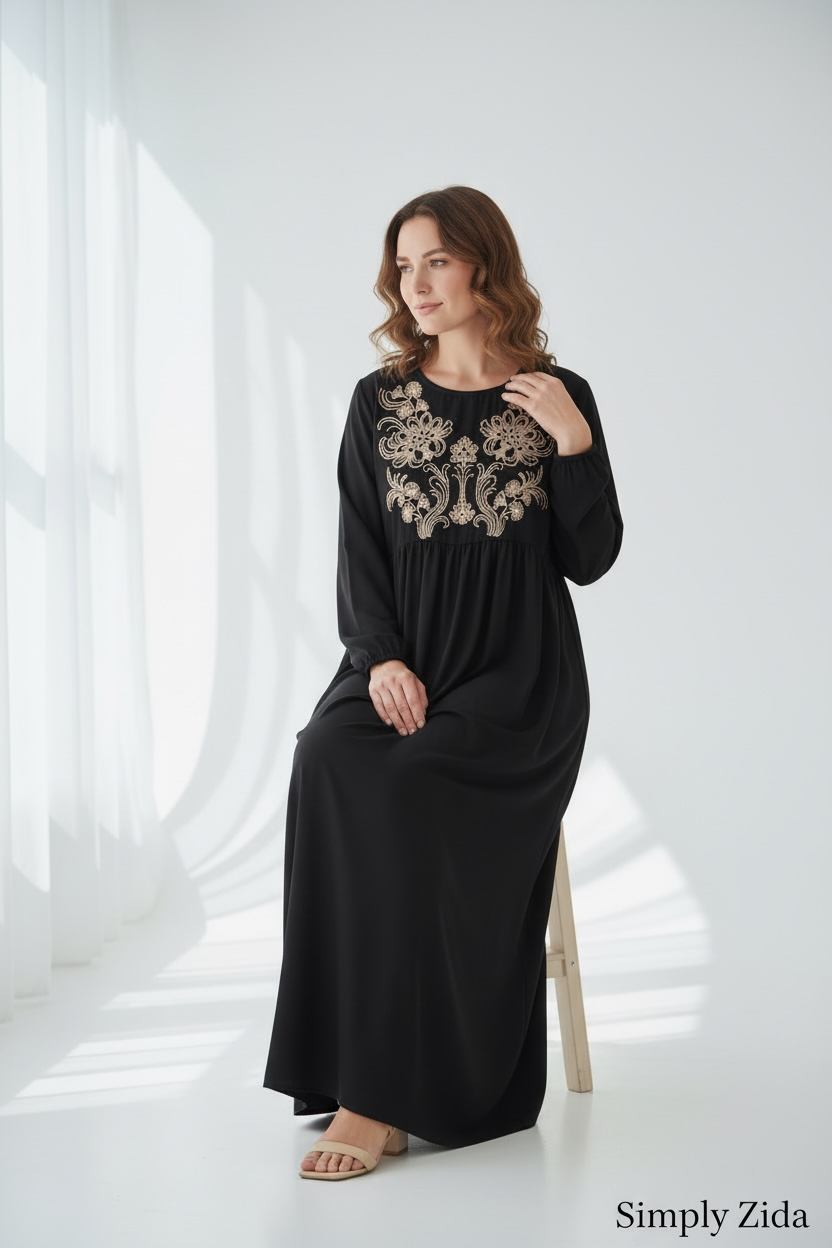 Black maxi abaya with gold floral embroidery on bodice, long sleeves and modest flowing silhouette front view.
