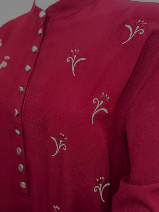 Close up of burgundy modest dress with subtle embroidery
