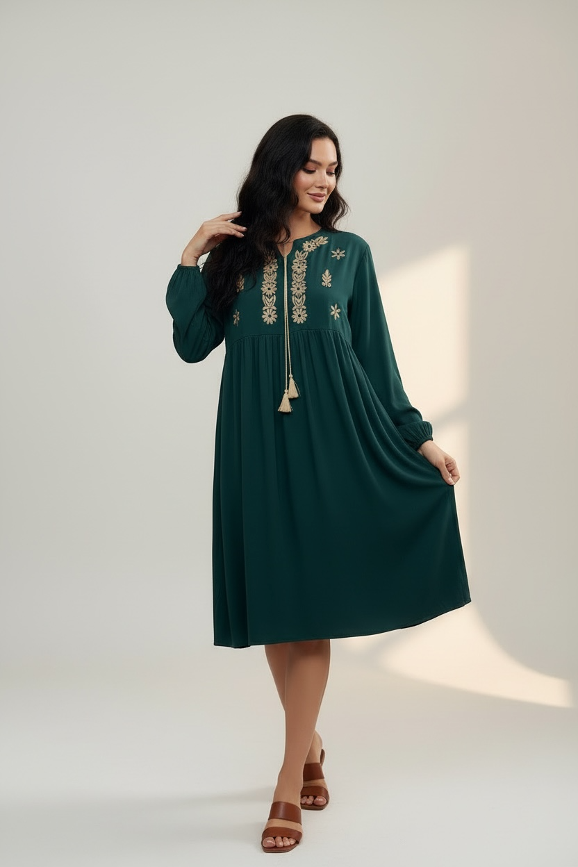 Front view of emerald green modest dress with tassel neckline
