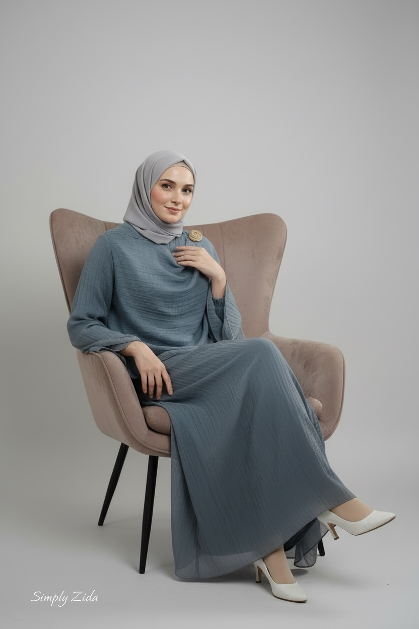 Elegant frosty blue layered abaya with flared sleeves and gold brooch detail
